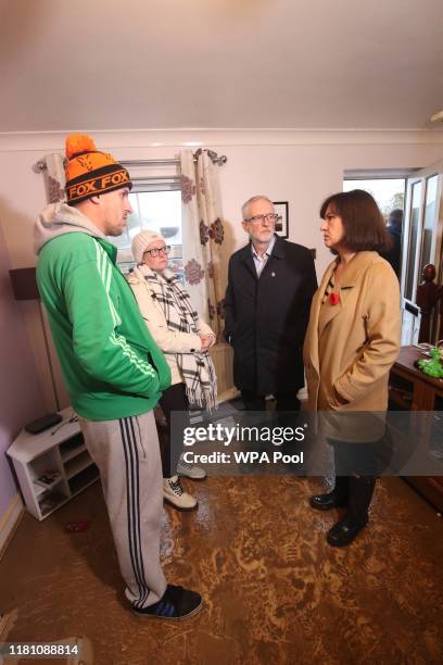 Labour leader Jeremy Corbyn and Labour MP Caroline Flint meet residents James Merritt and Alison Merritt in their house which was affected by...