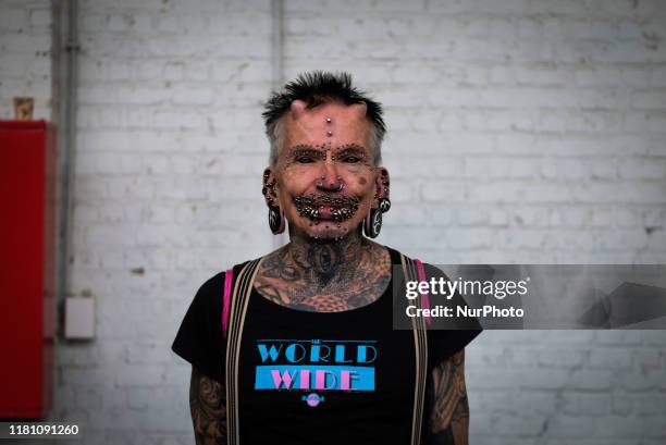 Man with full of tattoos and piercings in the International Brussels Tattoo Convention in Brussels, Belgium, on November 9, 2019.