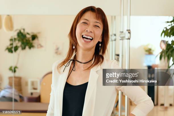 portrait of 53 year old female small business owner - japanese woman stock pictures, royalty-free photos & images