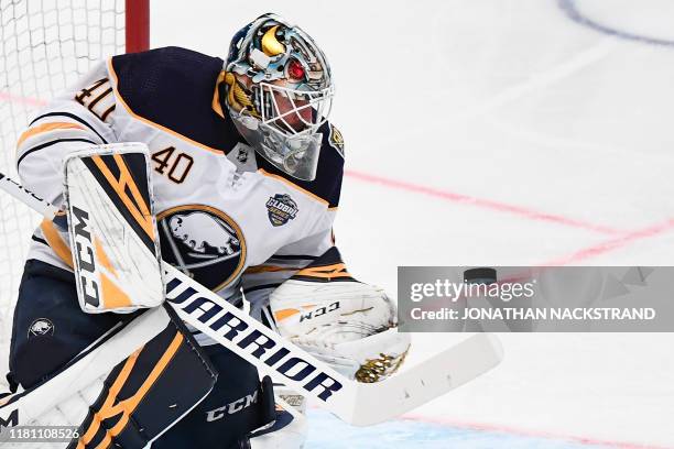 Goalkeeper Carter Hutton of Buffalo Sabres reacts to a shot during the NHL Global Series Ice Hockey match Tampa Bay Lightning v Buffalo Sabres in...