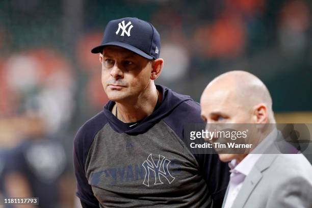 Manager Aaron Boone of the New York Yankees watches batting practice before game two of the American League Championship Series against the Houston...
