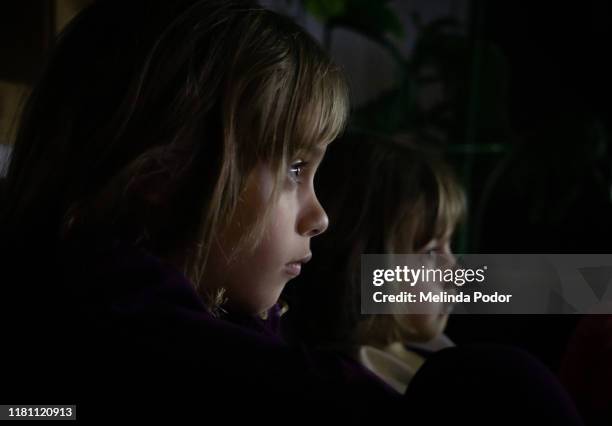 two children intently watching something - children screen stock pictures, royalty-free photos & images