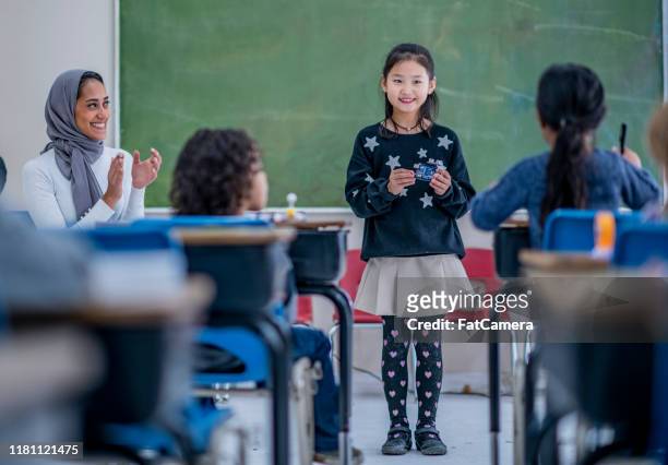 multi-ethnic elementary students in class stock photo - kid presenting stock pictures, royalty-free photos & images