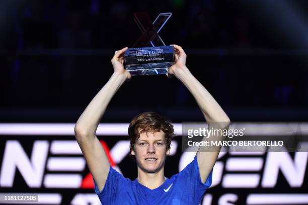 Italy's Jannik Sinner holds the winner's trophy after defeating Australia's Alex De Minaur during the final of the Next Generation ATP Finals at the...