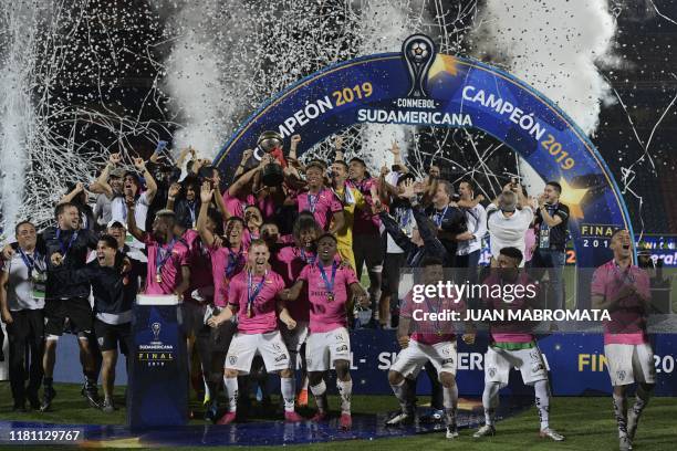 Players of Ecuador's Independiente del Valle celebrate on the podium with the trophy after winning the Copa Sudamericana final football match by...