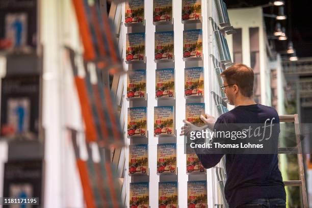 An employee puts books into a shelf at the Frankfurt Book Fair on October 15, 2019 in Frankfurt am Main, Germany. The 2019 fair, which is among the...