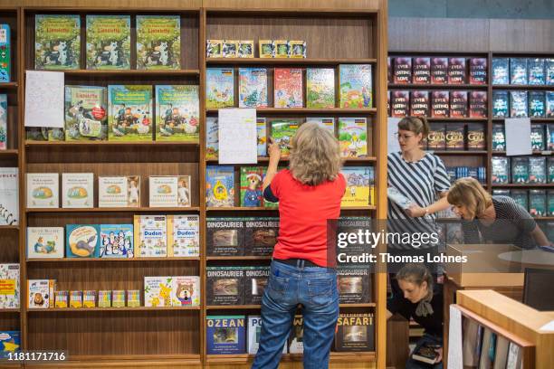 Employees puts books into a shelf at the Frankfurt Book Fair on October 15, 2019 in Frankfurt am Main, Germany. The 2019 fair, which is among the...