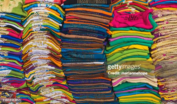 close-up of t-shirts for sale in a market, morocco - slogan t shirt stock-fotos und bilder