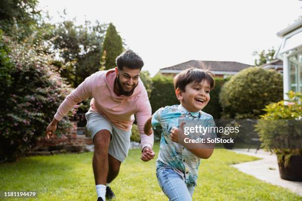 family playing in the garden - uk domestic garden stock pictures, royalty-free photos & images