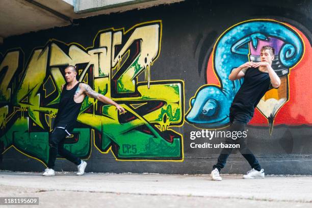 two men perform breakdance - freestyle dance stock pictures, royalty-free photos & images