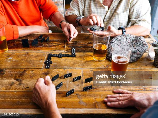 men playing dominoes - senior men beer stock pictures, royalty-free photos & images