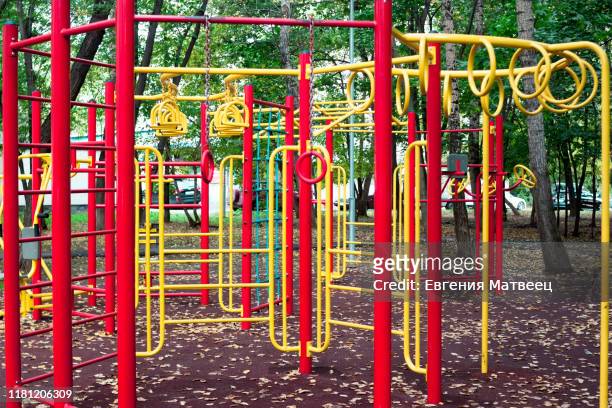 metal children's outdoor playground equipment bars swing yellow and red color - red tube 個照片及圖片檔