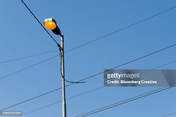 street lamp and electricity power lines - soweto towers stock pictures, royalty-free photos & images
