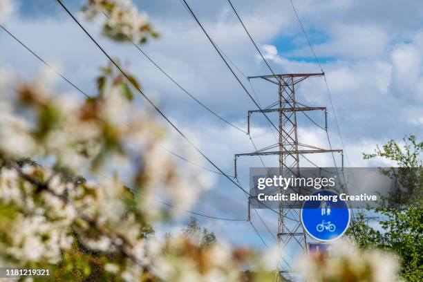electricity pylons against a blue sky - electric grid stock pictures, royalty-free photos & images