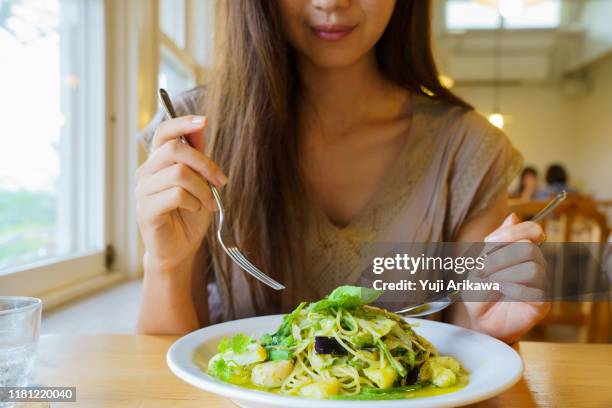 a woman starts her lunch - pesto sauce stock pictures, royalty-free photos & images