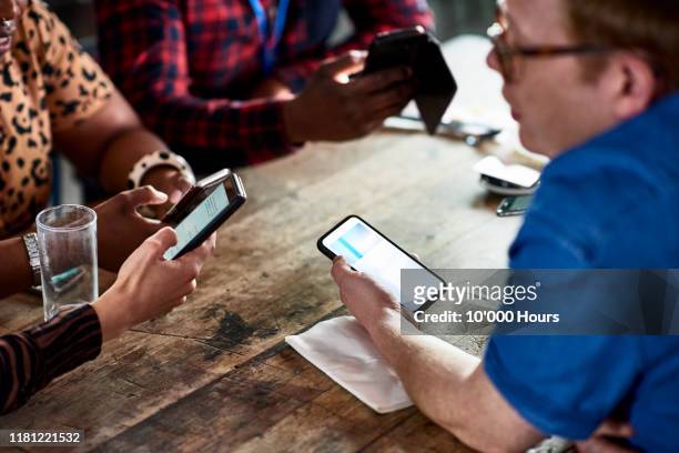 colleagues networking with smart phones - teamevenement stockfoto's en -beelden