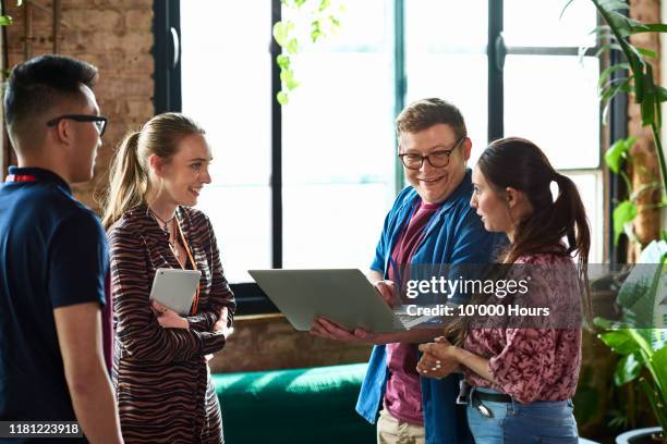 conference attendees in conversation during break - member meeting stock-fotos und bilder