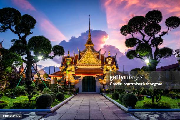 wat arun temple at sunset in bangkok thailand. wat arun is a buddhist temple in bangkok yai district of bangkok, thailand, wat arun is among the best known of thailand's landmarks - bangkok boat stock pictures, royalty-free photos & images