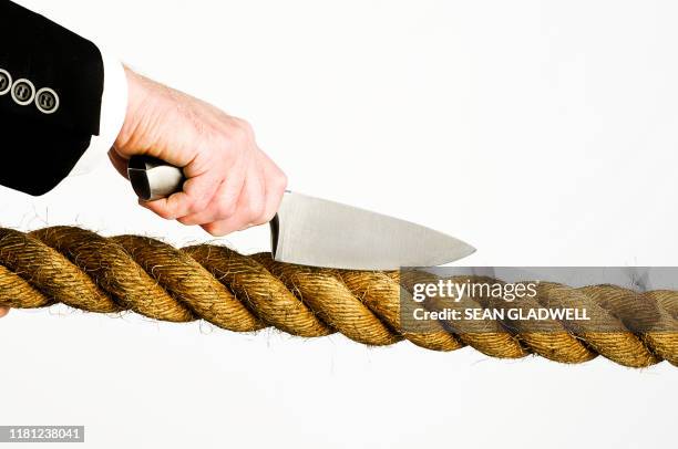 Cutting Through Ropes Man In Suit Holding Rope Photos and Premium High Res Pictures - Getty ...