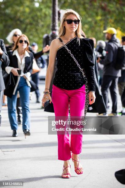 Jessica Minkoff, wearing a black velvet top and fuchsia pants, is seen outside the Sacai show during Paris Fashion Week - Womenswear Spring Summer...