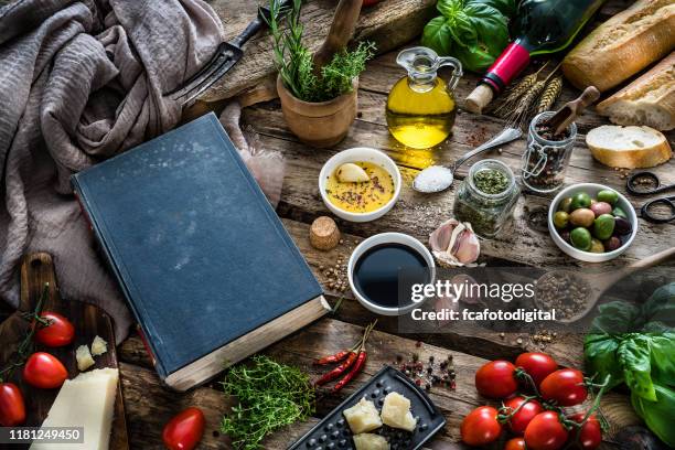 mediterranean ingredients, spices and cookbook on rustic table - food and drink imagens e fotografias de stock