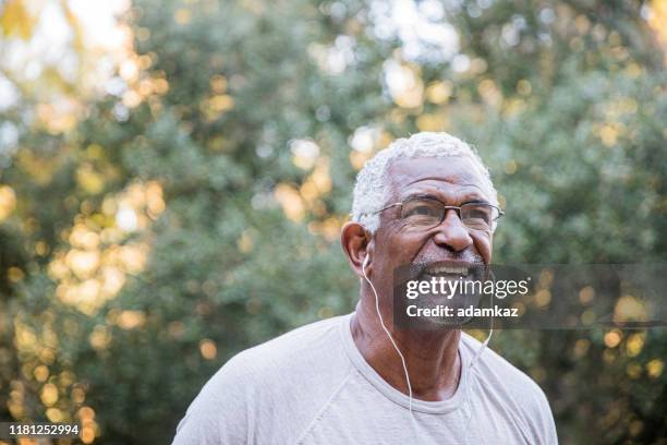 senior black man exploring - old person with headphones stock pictures, royalty-free photos & images