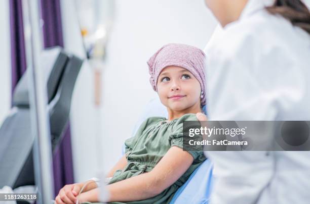 smiling little girl with cancer stock photo - children hospital stock pictures, royalty-free photos & images