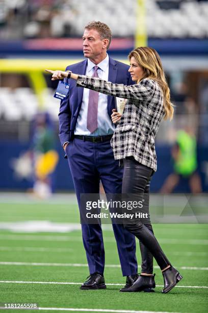 Troy Aikman and Erin Andrews talk on the field before a game between the Green Bay Packers and the Dallas Cowboys at AT&T Stadium on October 6, 2019...