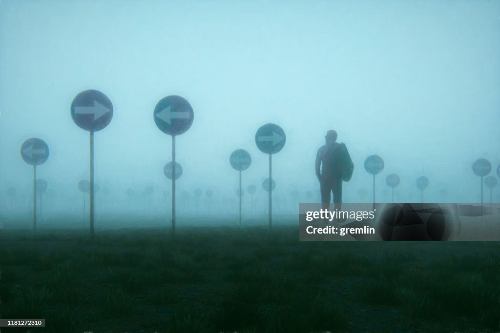 Lost and confused businessman walking in meadow