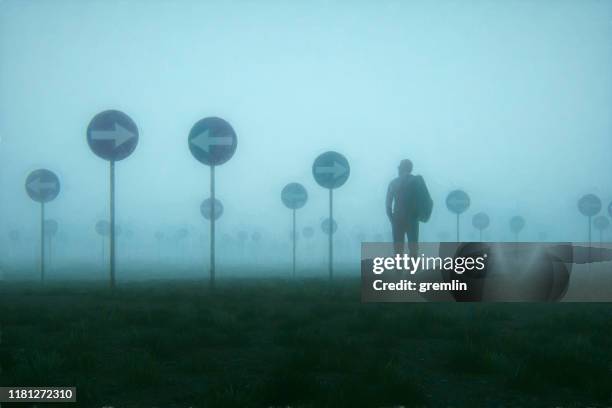 lost and confused businessman walking in meadow - orientação-conceito imagens e fotografias de stock