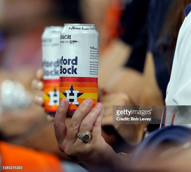 Fans holds a can of Karbach Crawford Bock beer during game two of the American League Championship Series at Minute Maid Park on October 13, 2019 in...