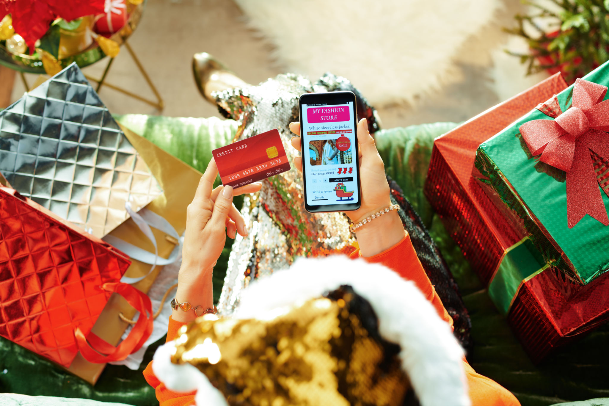 modern female buying clothes online in room at Christmas modern female buying clothes online in room at Christmas