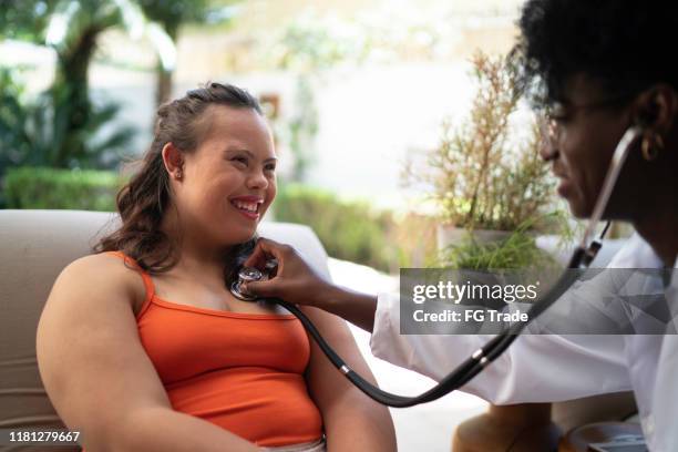 special needs woman being examining - down syndrome care stock pictures, royalty-free photos & images