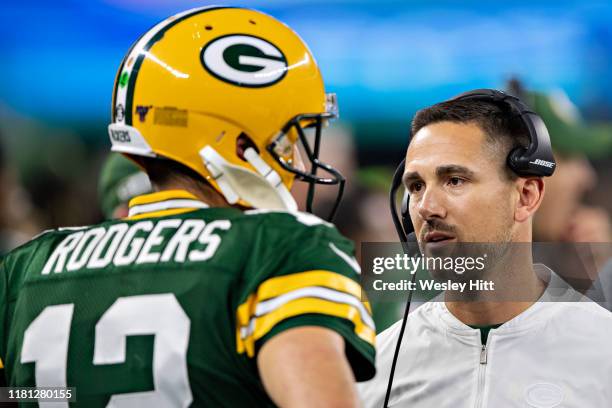 Head Coach Matt LaFleur talks with Aaron Rodgers of the Green Bay Packers on the sidelines during a game against the Dallas Cowboys at AT&T Stadium...