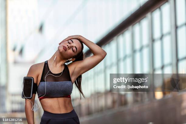 beautiful sportive girl stretching her neck - girl neck stock pictures, royalty-free photos & images