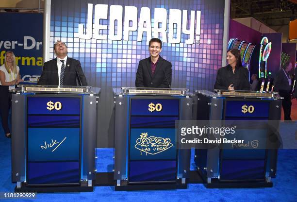Professional sports gambler and former "Jeopardy!" champion James Holzhauer plays "Jeopardy!" against attendees at the IGT booth during the trade...