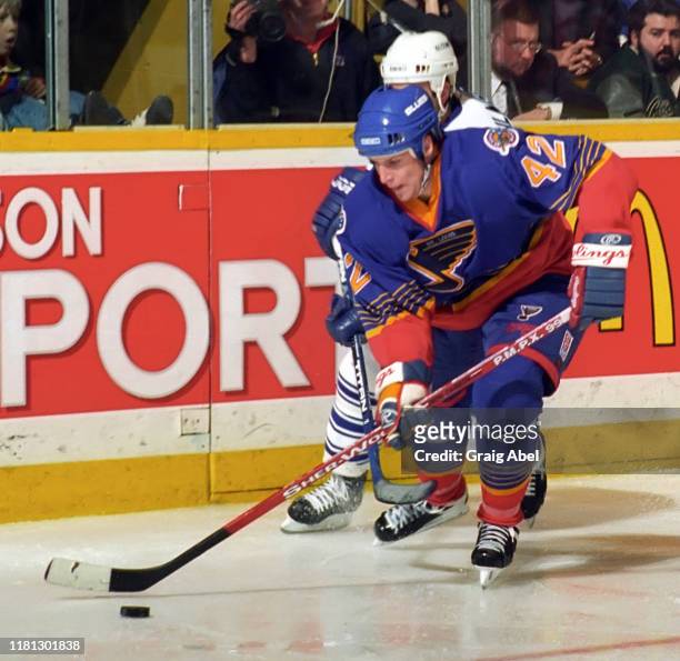 Rory Fitzpatrick of the St. Louis Blues skates against Doug Gilmour of the Toronto Maple Leafs during NHL game action on December 3, 1996 at Maple...