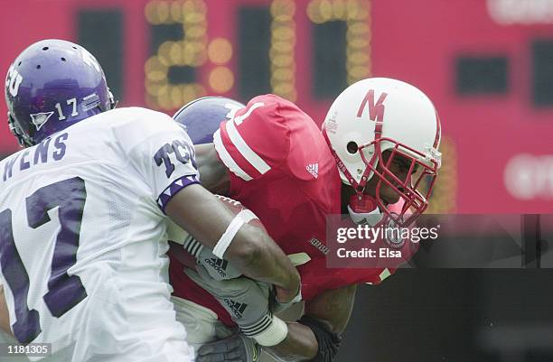 Running back Thunder Collins of the Nebraska Cornhuskers protects the ball from safety Charlie Owens of the Texas Christian University Horned Frogs...