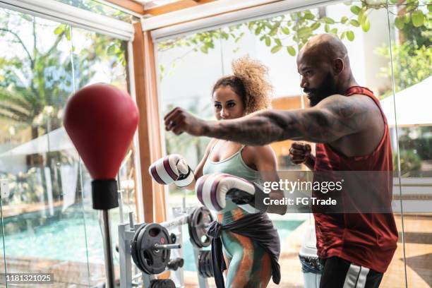 personal trainer and female boxer training - fitness instructor at home stock pictures, royalty-free photos & images