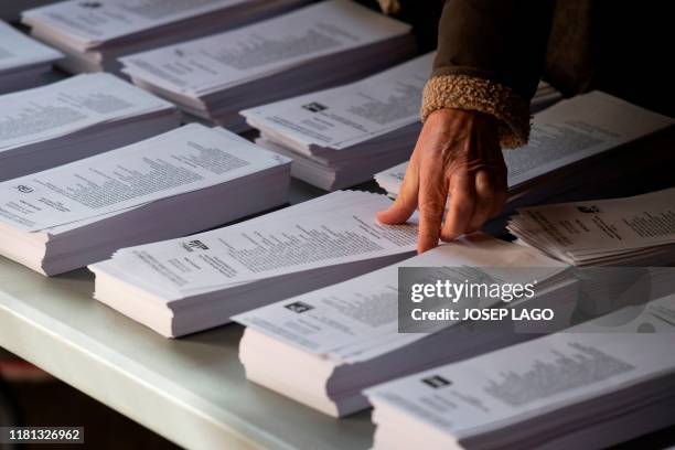 Woman prepares her ballots at a polling station in Barcelona on November 10, 2019 during a general election in Spain. - Spain holds its fourth...