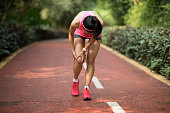 Female runner suffering with sports injury on running