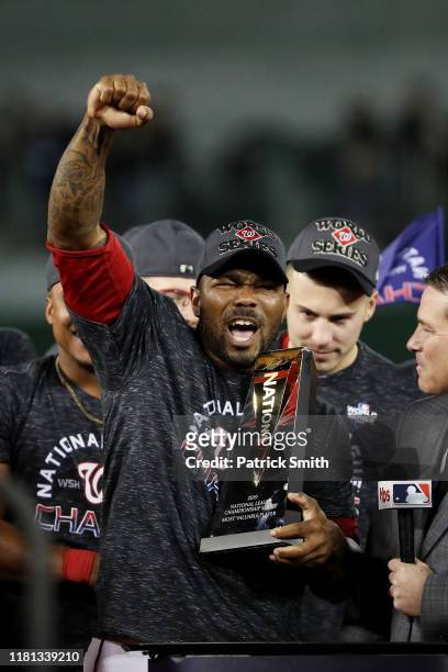 Howie Kendrick of the Washington Nationals celebrates with the MVP trophy after winning game four and the National League Championship Series against...