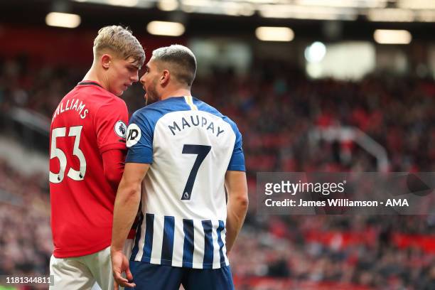 Brandon Williams of Manchester United clashes with Neal Maupay of Brighton and Hove Albion during the Premier League match between Manchester United...