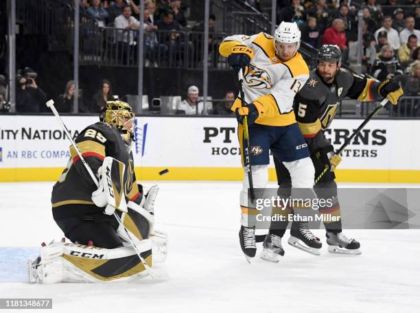 Nick Bonino of the Nashville Predators tips a shot by teammate Kyle Turris a past Marc-Andre Fleury of the Vegas Golden Knights for a power-play goal...