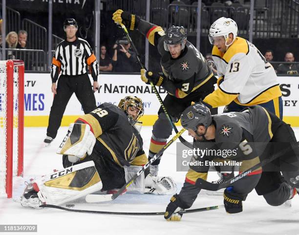 Marc-Andre Fleury of the Vegas Golden Knights blocks a shot by Nick Bonino of the Nashville Predators as Brayden McNabb and Deryk Engelland of the...