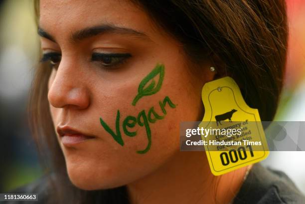 An animal rights activist seen with a cattle tag during a demonstration against animal cruelty and promotion of vegan diet, at Mandi House, on...