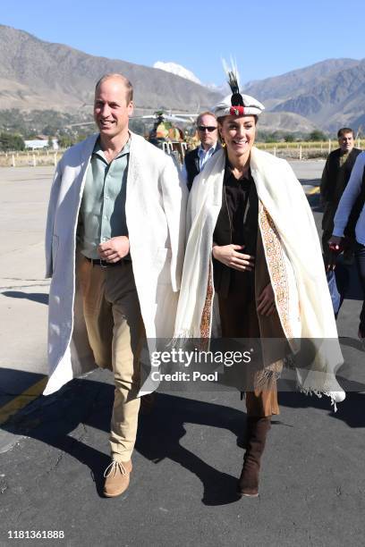 Prince William, Duke of Cambridge and Catherine, Duchess of Cambridge are welcomed as they arrive by helicopter on October 16, 2019 in Chitral,...