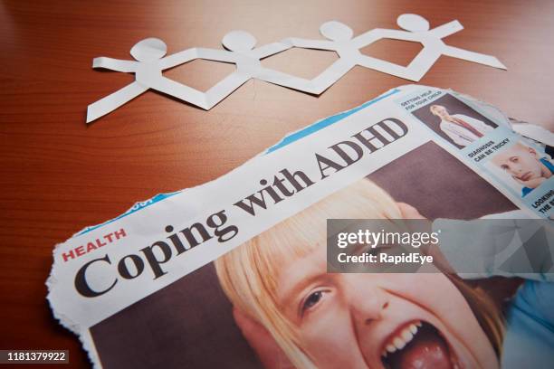 newspaper headline: "coping with adhd" illustrated by screaming child - adhs stock pictures, royalty-free photos & images