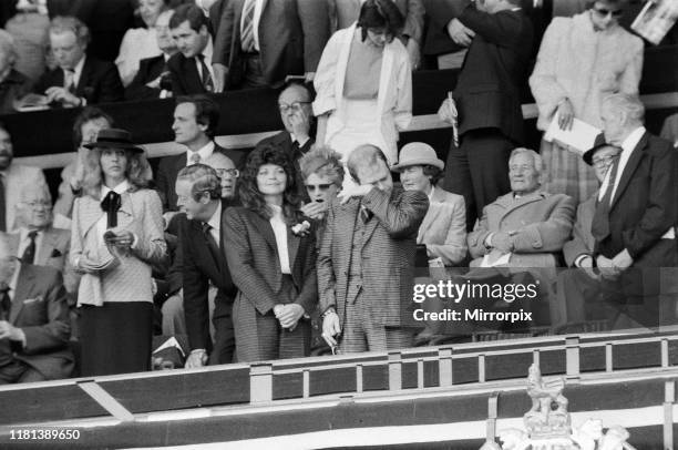 Watford chairman Elton John sheds a tear. His new wife Renate soaks up the atmosphere. And one lady looks very bored with 90 minutes still to go. The...