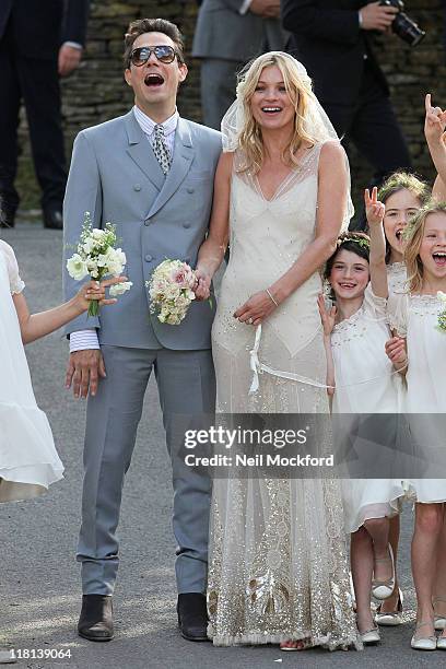 Kate Moss and Jamie Hince pose outside the church after getting married on July 1, 2011 in Southrop, England.